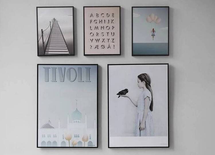 Five random pictures in frames on a wall